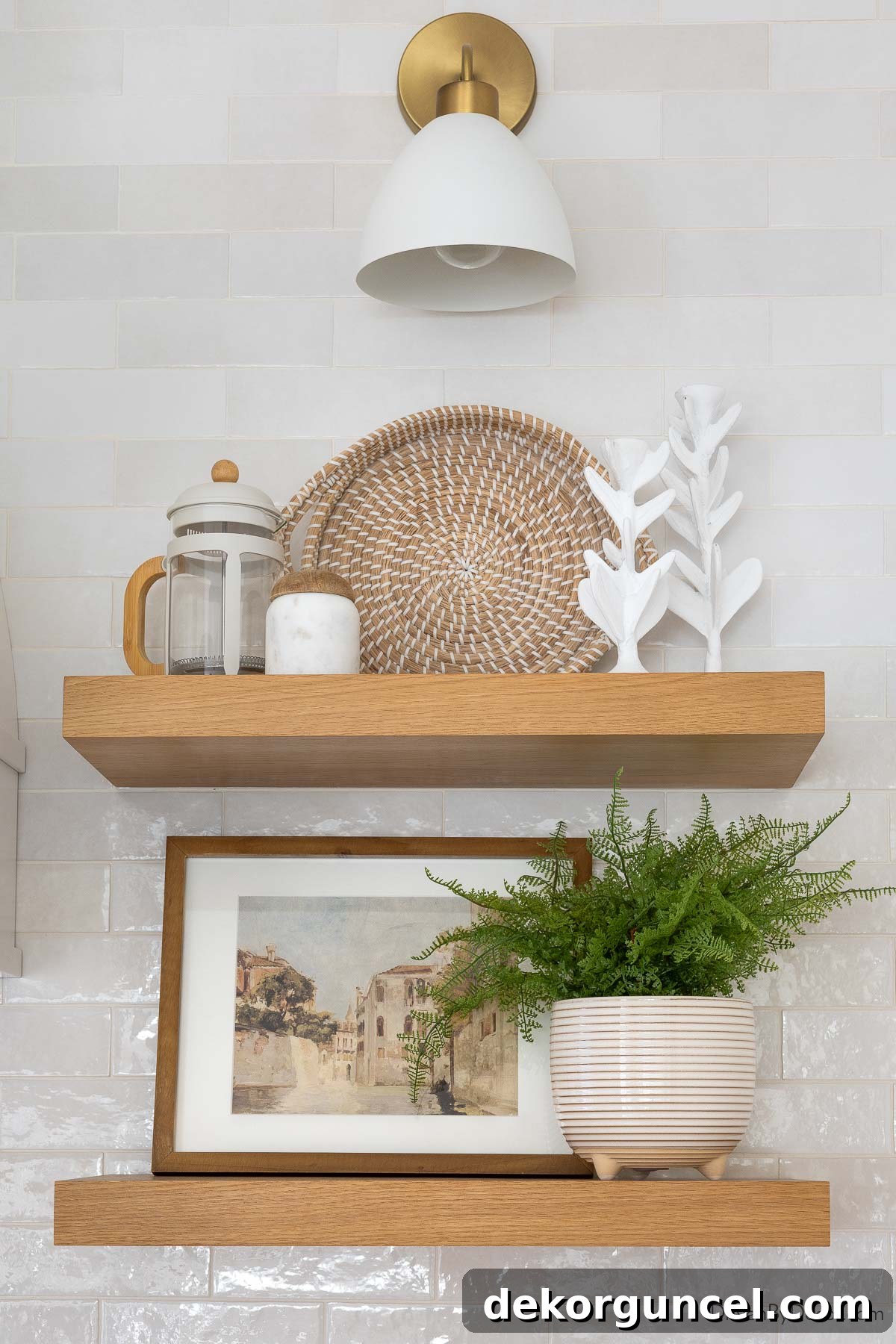 Pair of white oak floating wood shelves in the kitchen, adorned with a plant, framed art, and decorative items