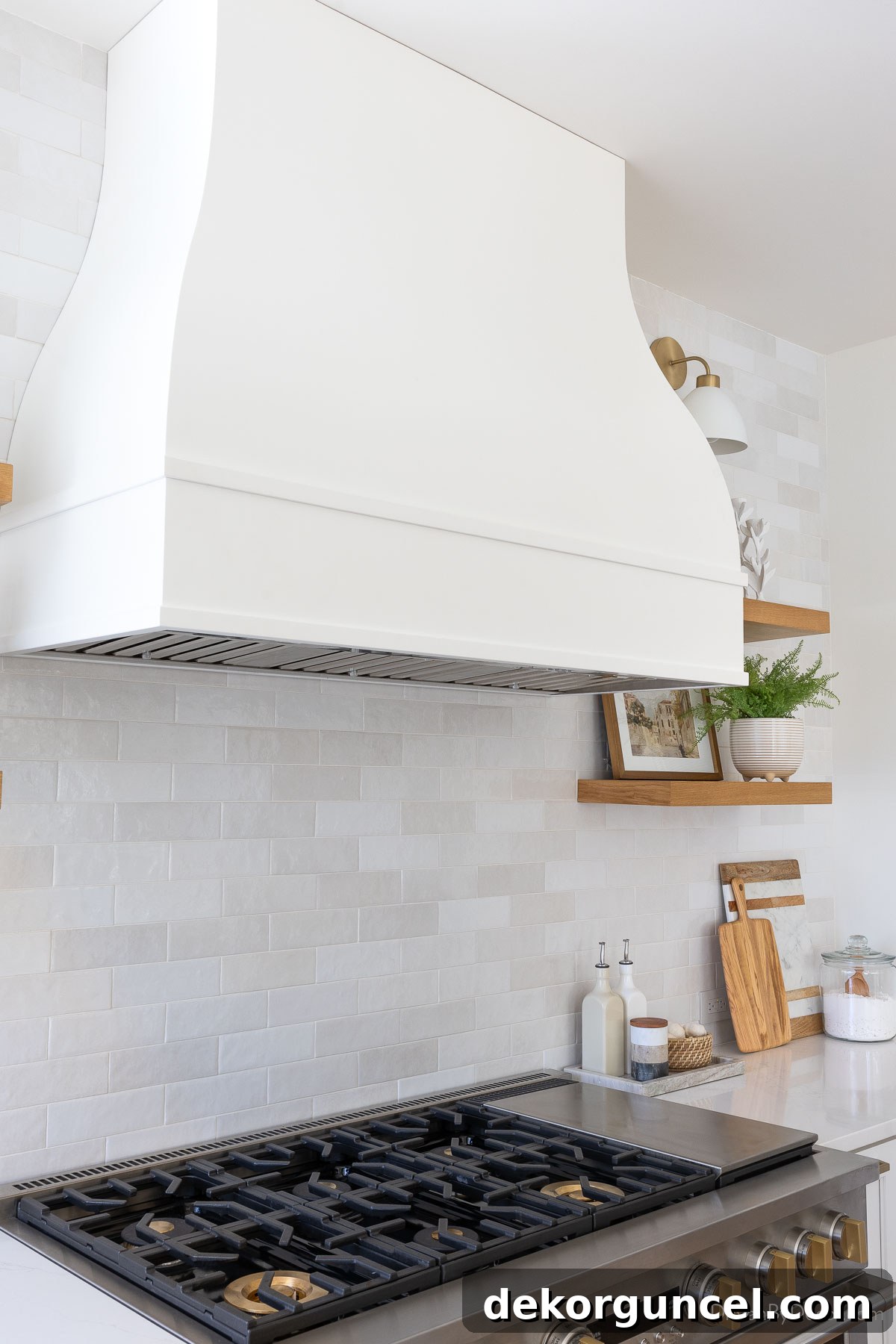 Elegant bell-shaped range hood installed above the kitchen range, serving as a focal point