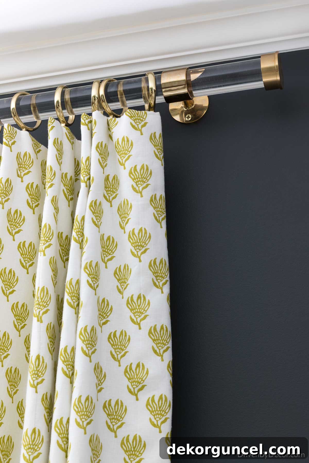 Acrylic curtain rod with brass brackets, rings, and endcaps
