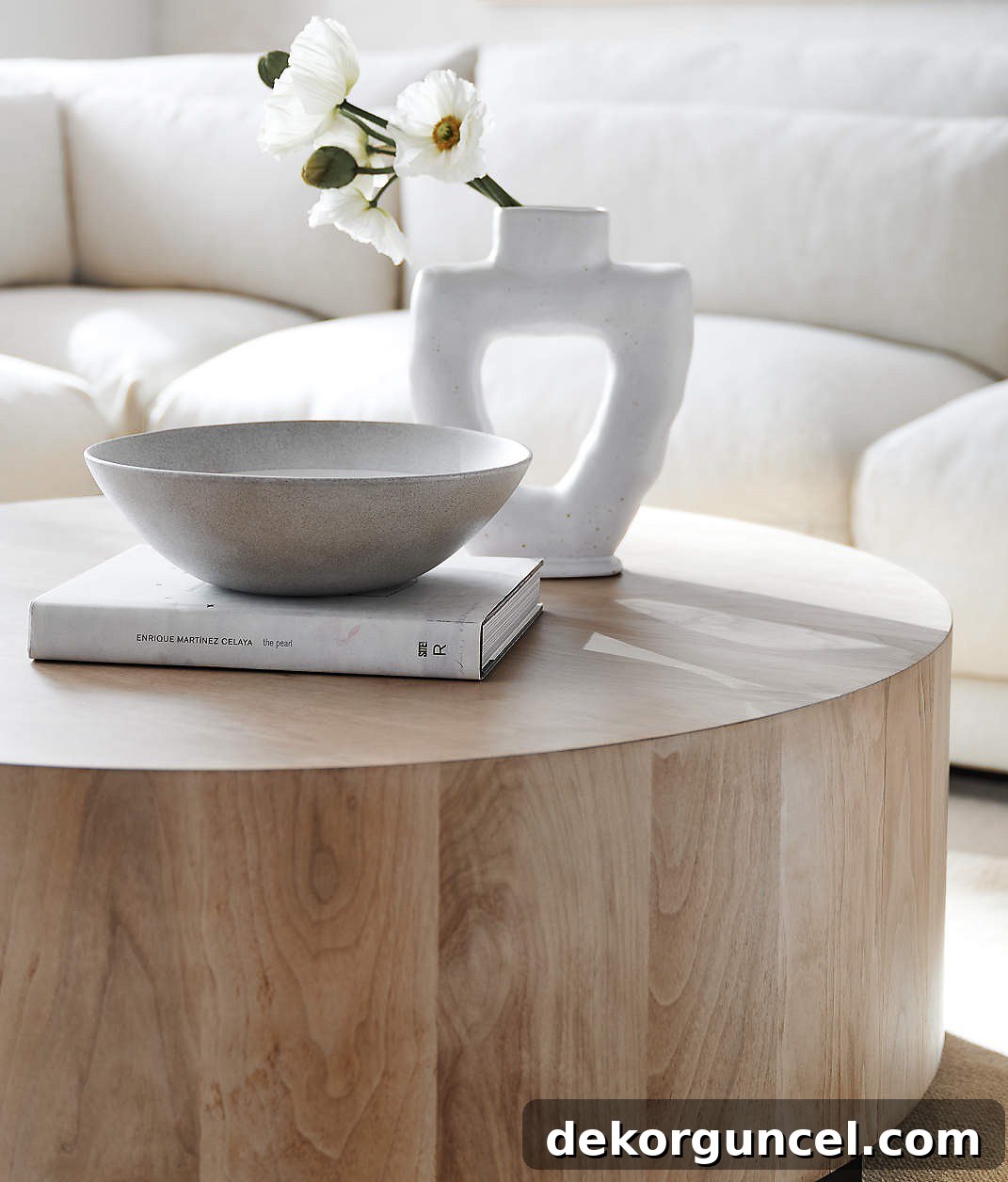 Round coffee table with book, bowl, and vase