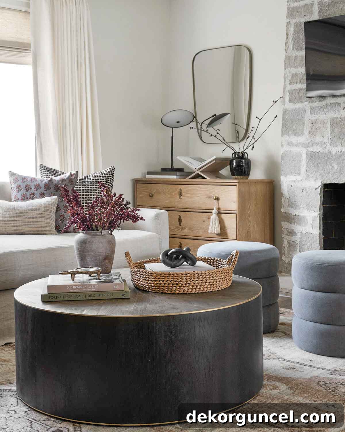 Round coffee table with vase, round tray, and stack of books