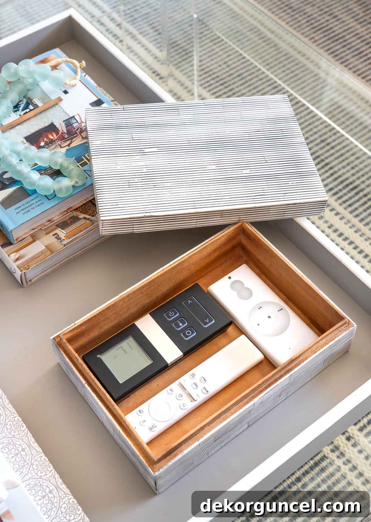 Decorative pinstripe box holding remote controls