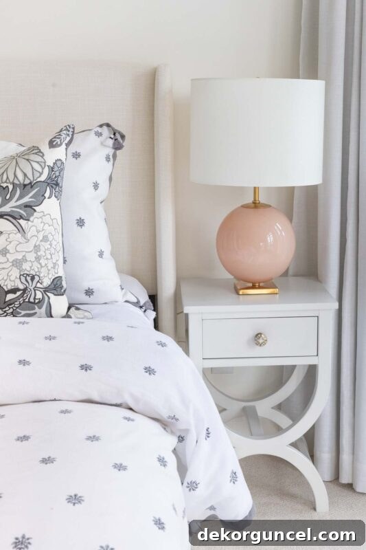 Narrow cross-base nightstand in off-white for small spaces