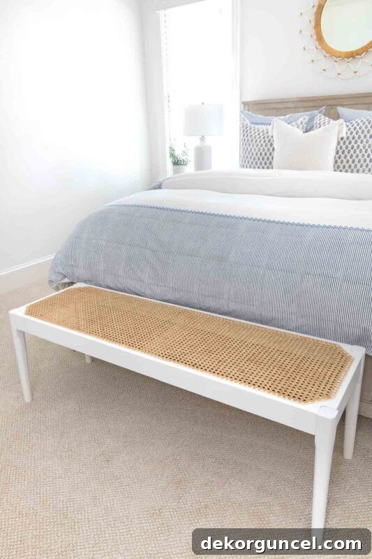 Cane bench at the foot of a bed in a guest room