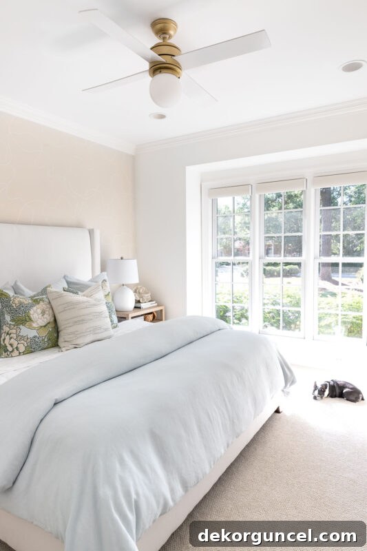 Stylish globe ceiling fan with reversible blades in a bedroom