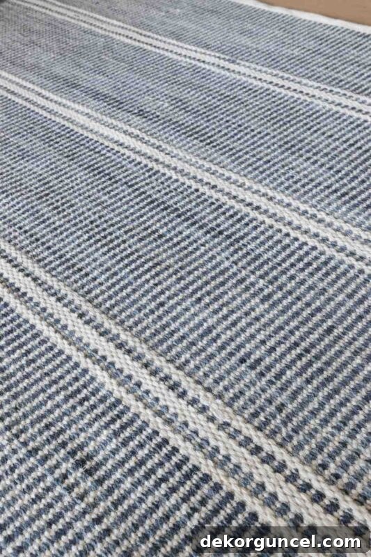 Durable blue and white striped low-pile rug in family room