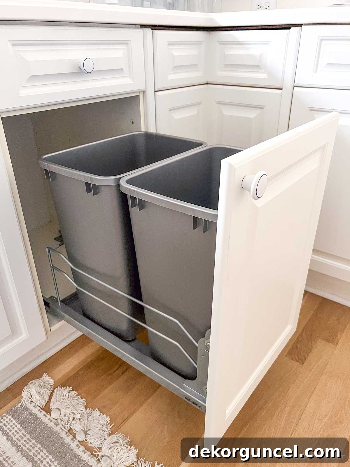 DIY conversion of a standard kitchen cabinet into a double trash pull-out system.