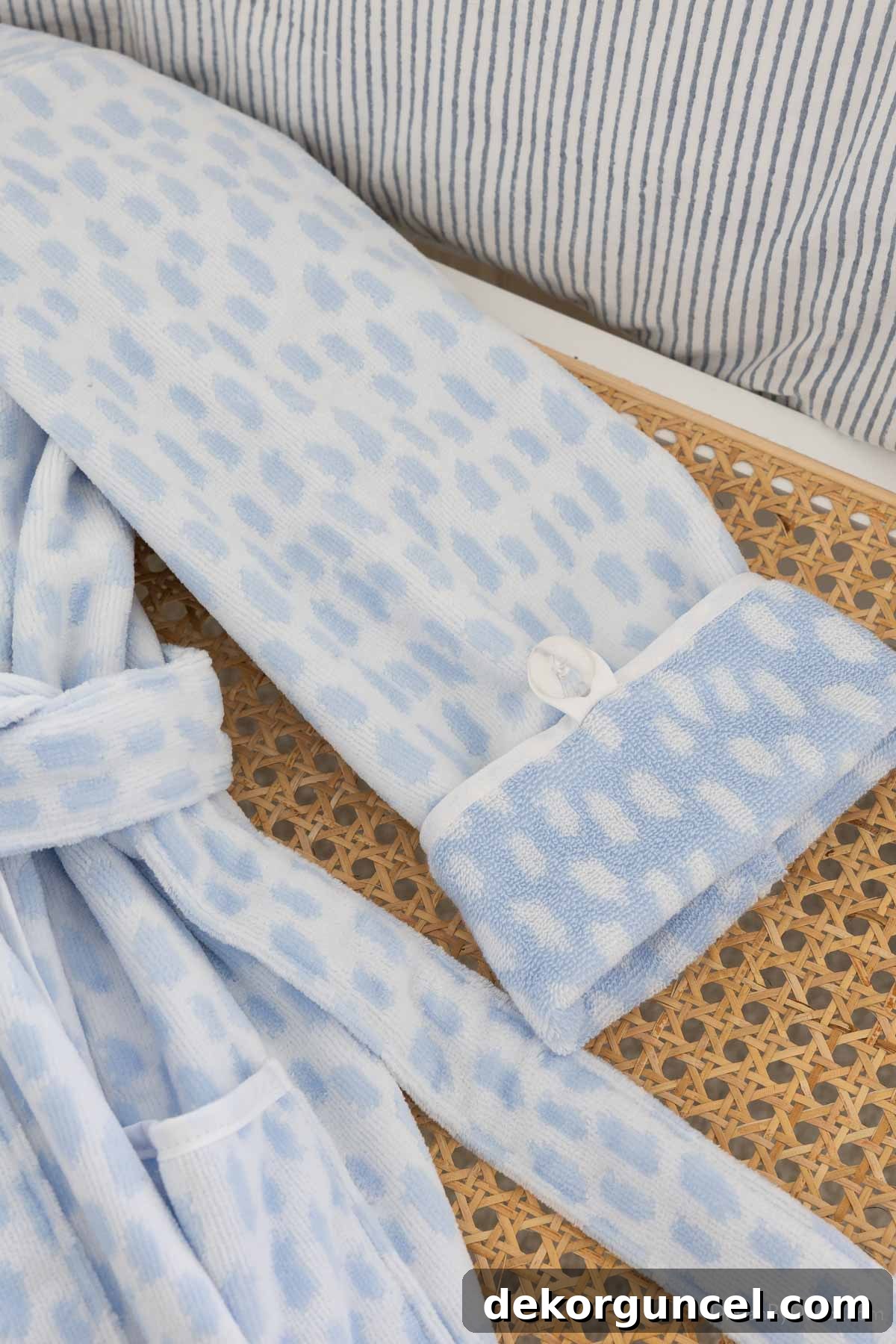Sleeve of plush robe showing button that keeps rolled up sleeves in place