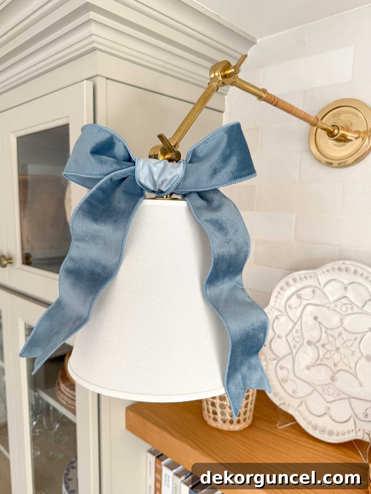 Blue velvet bow tied on a coffee bar sconce as part of Christmas decor