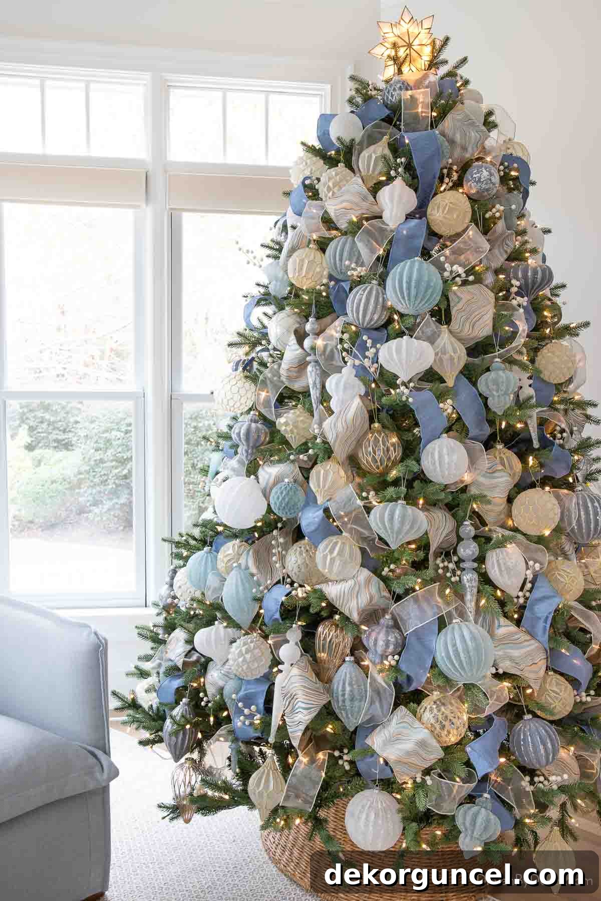 Coastal Christmas tree in a sunroom with woven tree collar and blue and white ornaments