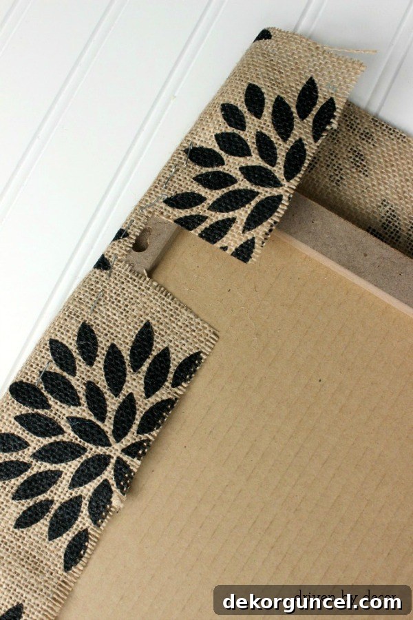 Detailed tutorial for securely stapling burlap fabric onto a cork board, ensuring a smooth finish