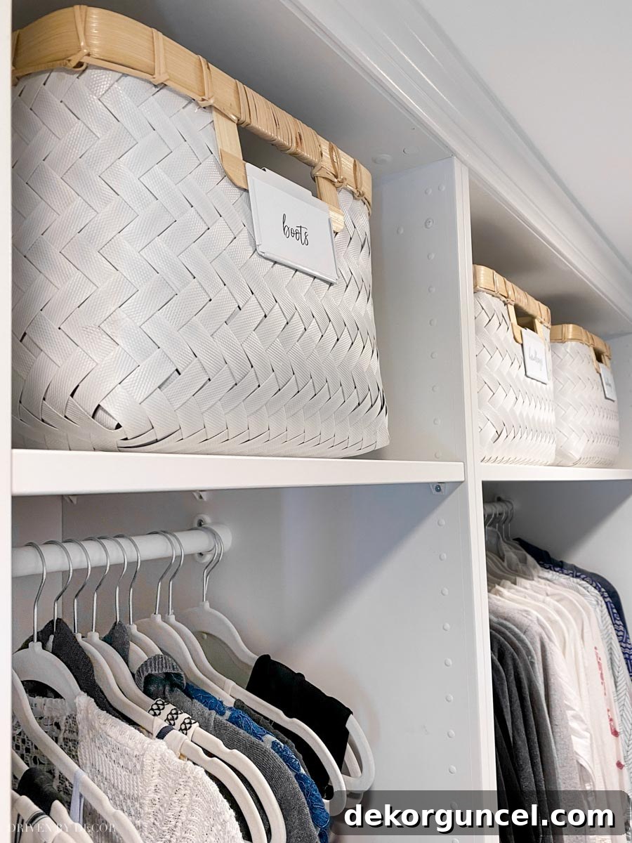 Spacious IKEA PAX wardrobe interiors on the deep side, featuring large storage baskets on top shelves and neatly hung clothes on KOMPLEMENT rails.