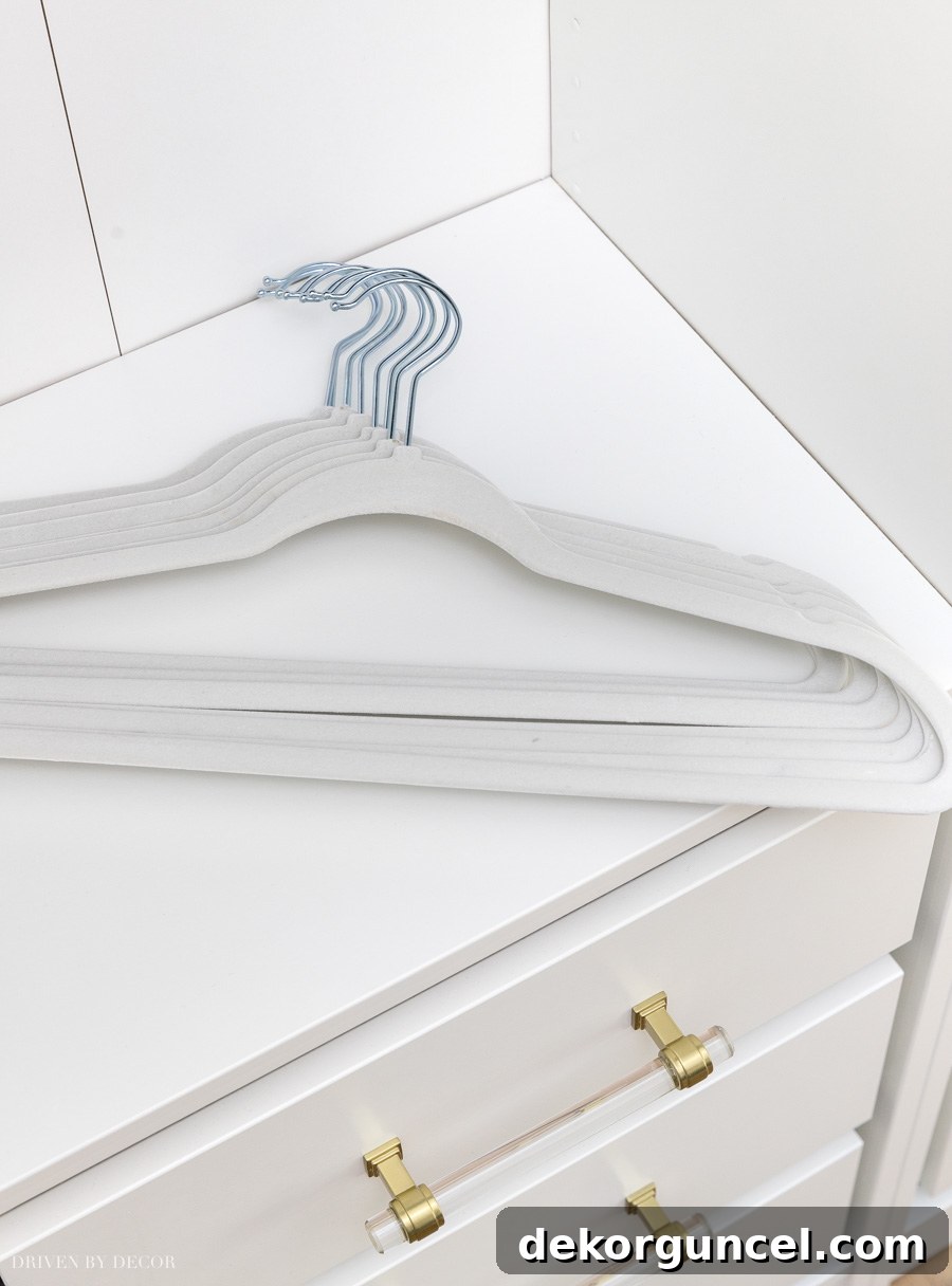 Close-up of non-slip velvet space-saving hangers in an IKEA PAX wardrobe, demonstrating their efficiency for maximizing hanging capacity.