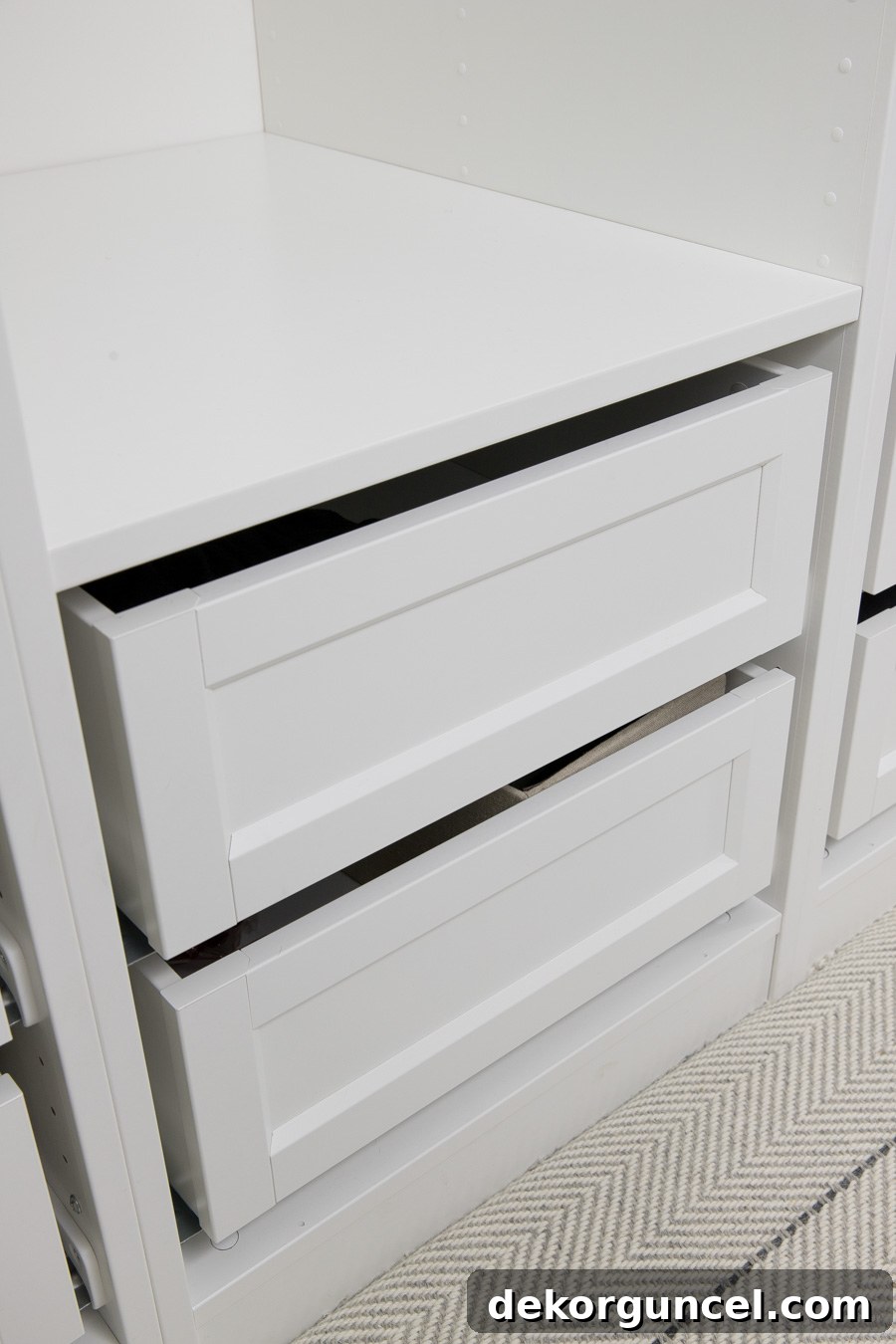 Elegant new framed-front KOMPLEMENT drawers in an IKEA PAX closet system, offering a sophisticated, high-end look.
