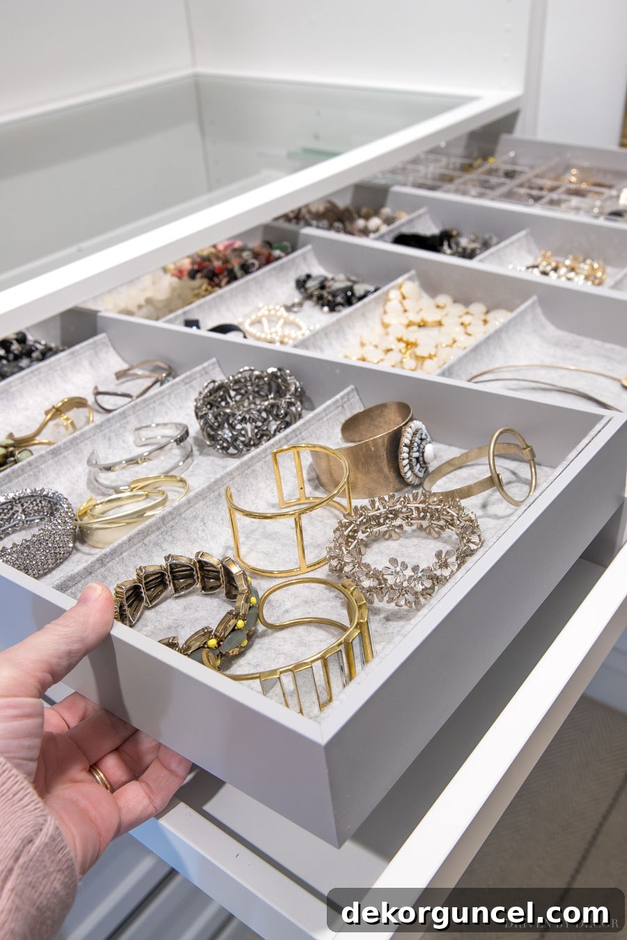 A customizable IKEA PAX pull-out tray with various KOMPLEMENT interior organizers, perfect for jewelry and small accessory storage.