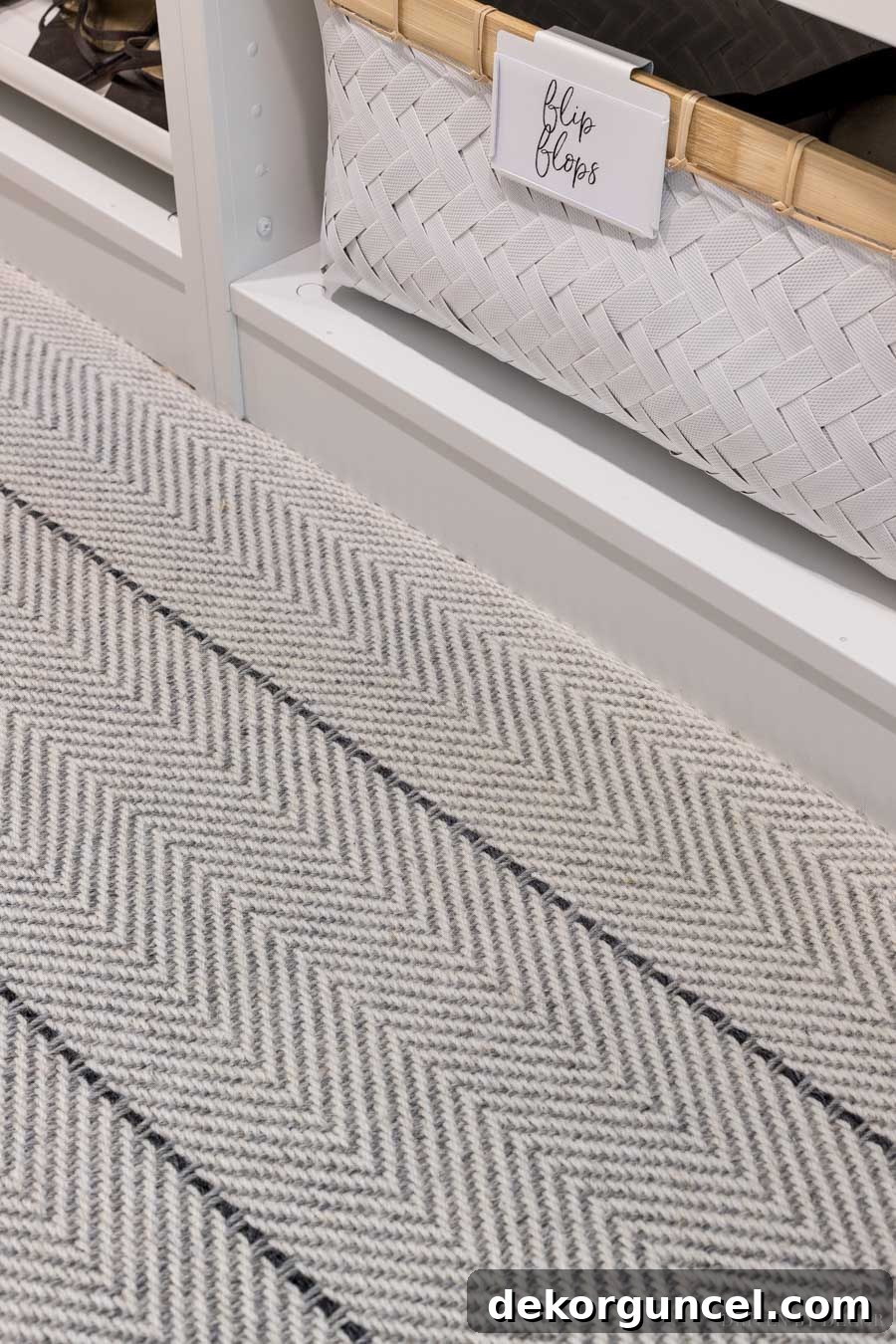 Elegant Peter Island Stripe carpet in Graphite in a master bedroom closet, adding comfort and style.