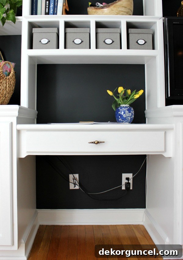 Visual example of significant cord clutter under a desk in a home office before organization
