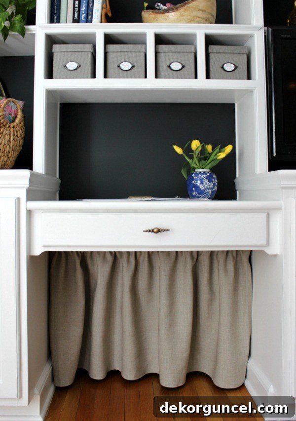 After photo showing a simple DIY fabric skirt covering all of the under the desk cord clutter for a tidy look