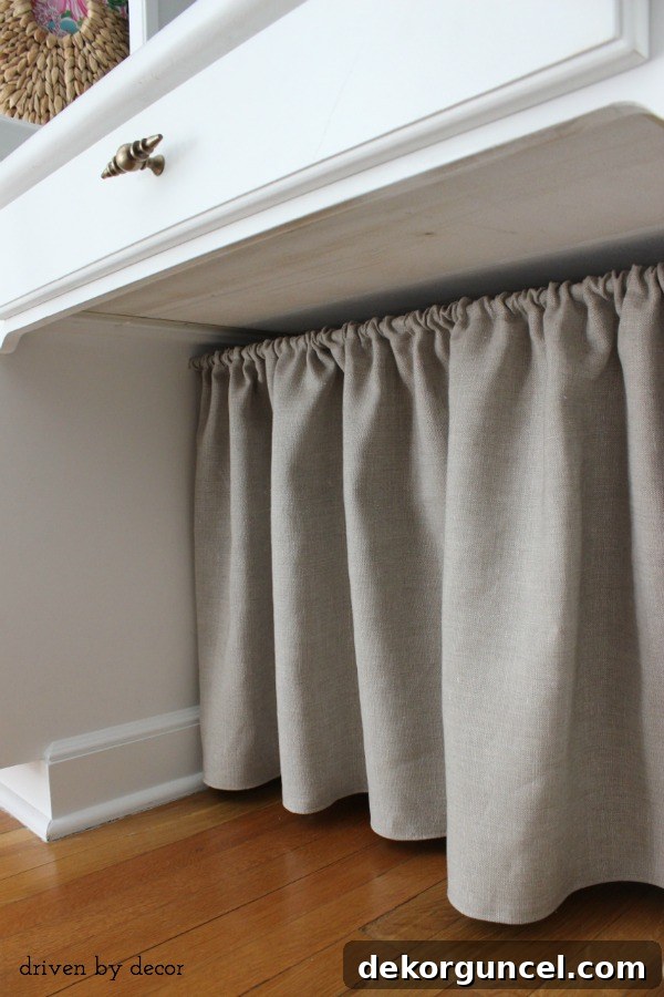 Detailed image showing the DIY fabric skirt under a desk, highlighting its effectiveness in hiding cord clutter