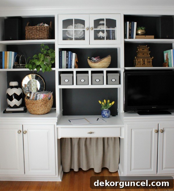 Home office bookcase with a stylish DIY fabric skirt installed to effectively cover all cord clutter