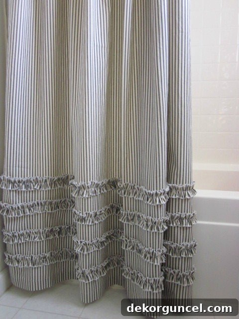 Chic ticking stripe shower curtain adding a classic touch to bathroom decor.