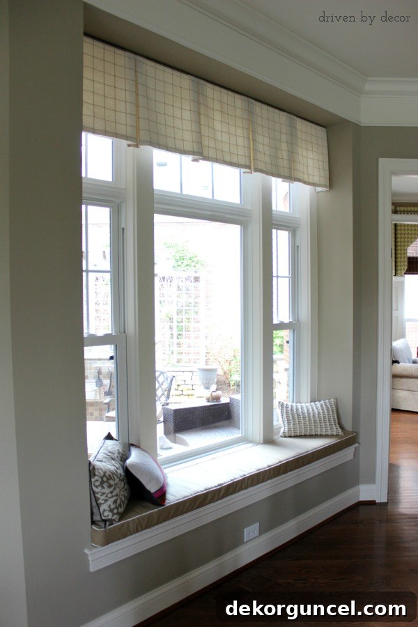 Tailored valence elegantly adorning a recessed window above a family room bench seat, enhancing the cozy atmosphere.