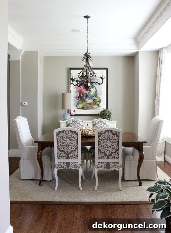 Open plan dining room with mixed seating and a long wall of windows, showcasing natural light and elegant decor.