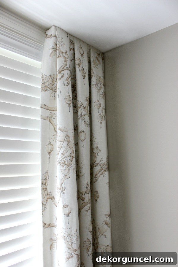 Close-up of simple pleated dining room drapes mounted on short boards, a clever solution for windows extending to the corner.