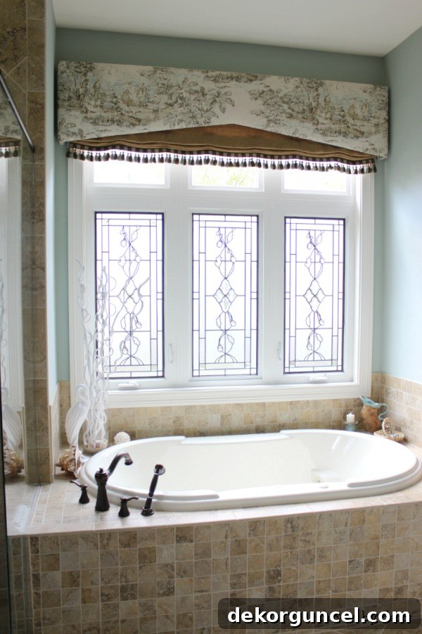 Bathroom window adorned with a beautifully layered valence, adding softness and decorative flair to a recessed window.