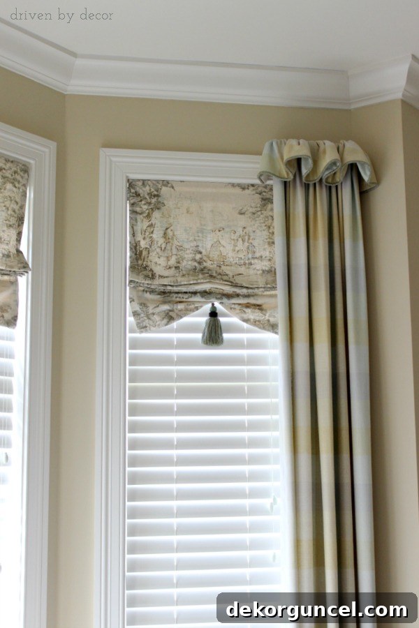 Elegant bay window treatment featuring individual faux shades for each pane, framed by puddled drapes with charming ruffled tops.