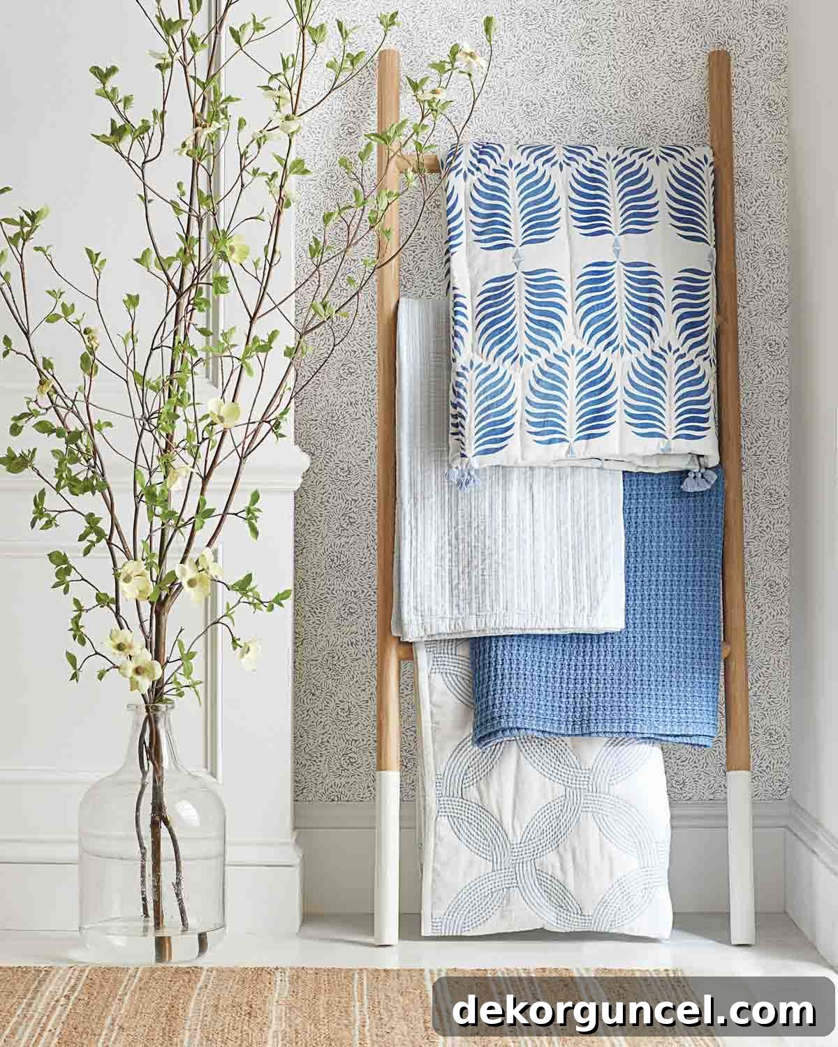Elevate Your Home Decor With Clever Ladder Designs 2 Throw blankets hung on the rungs of a decorative ladder