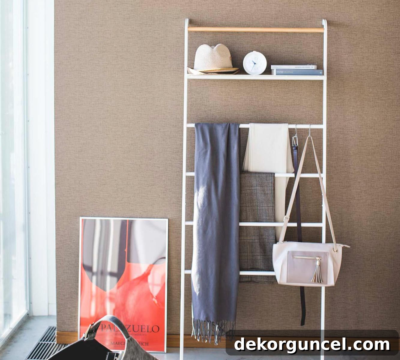Elevate Your Home Decor With Clever Ladder Designs 11 Decorative ladder with scarves, hat, & purse hung on the rungs