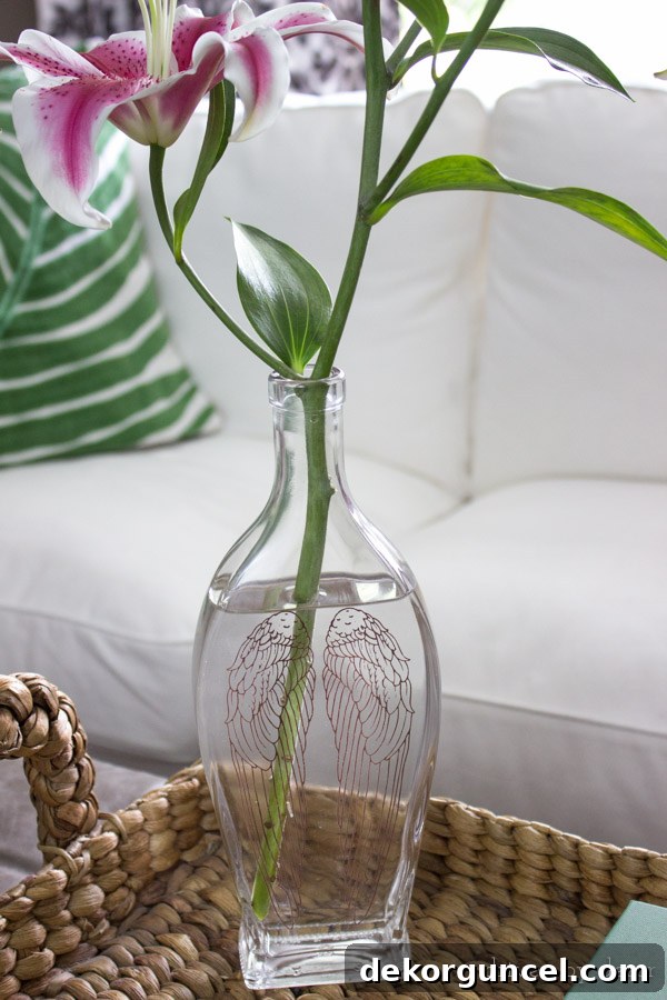 Decorative liquor bottle used as vase after using an easy trick to remove the bottle lettering