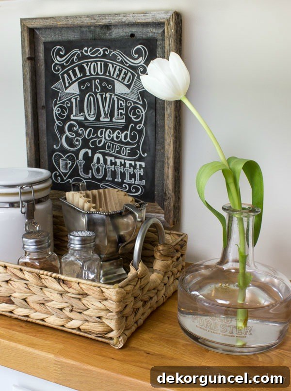 Old liquor bottle used as bud vase (next to cool kitchen coffee station!) sean