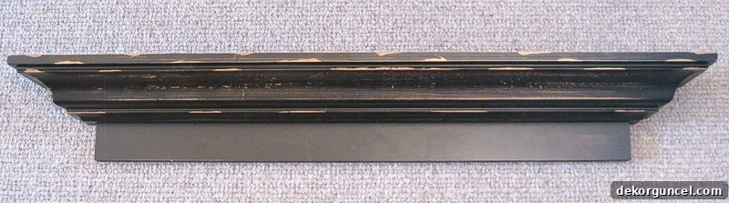 A distressed black ledge shelf transformed into an elegant trophy and medal display.