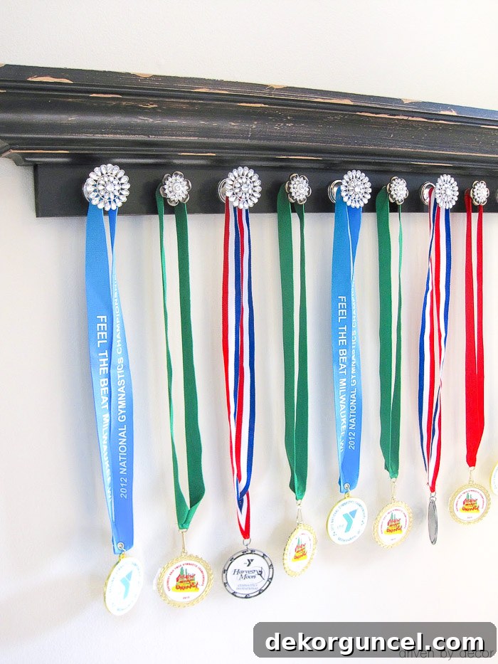 A charming ledge shelf with attached knobs serves as an ideal and creative holder for sports medals.