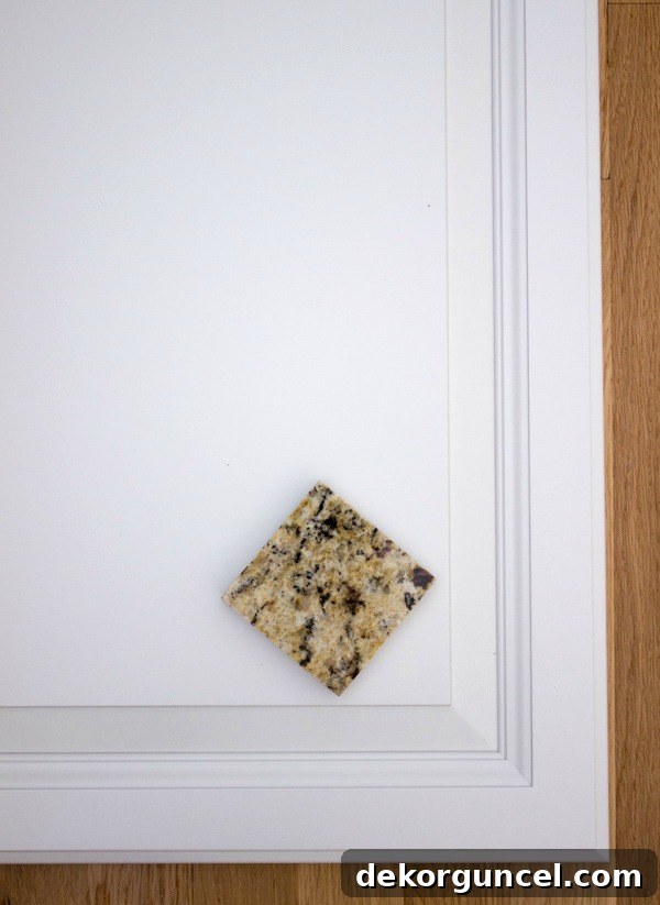 My Go-To Affordable Granite 8 New Venetian Gold granite in a kitchen setting with white cabinets, creating a bright and inviting space