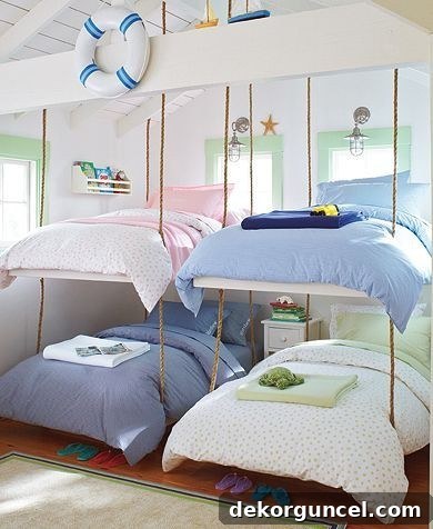 Children's bunk beds suspended from the ceiling with thick rope, creating a unique and space-saving bedroom design.