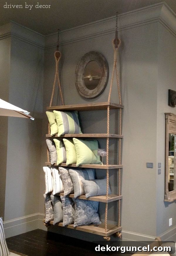 Restoration Hardware inspired shelving unit suspended by thick ropes and antique pulleys, offering stylish open storage.