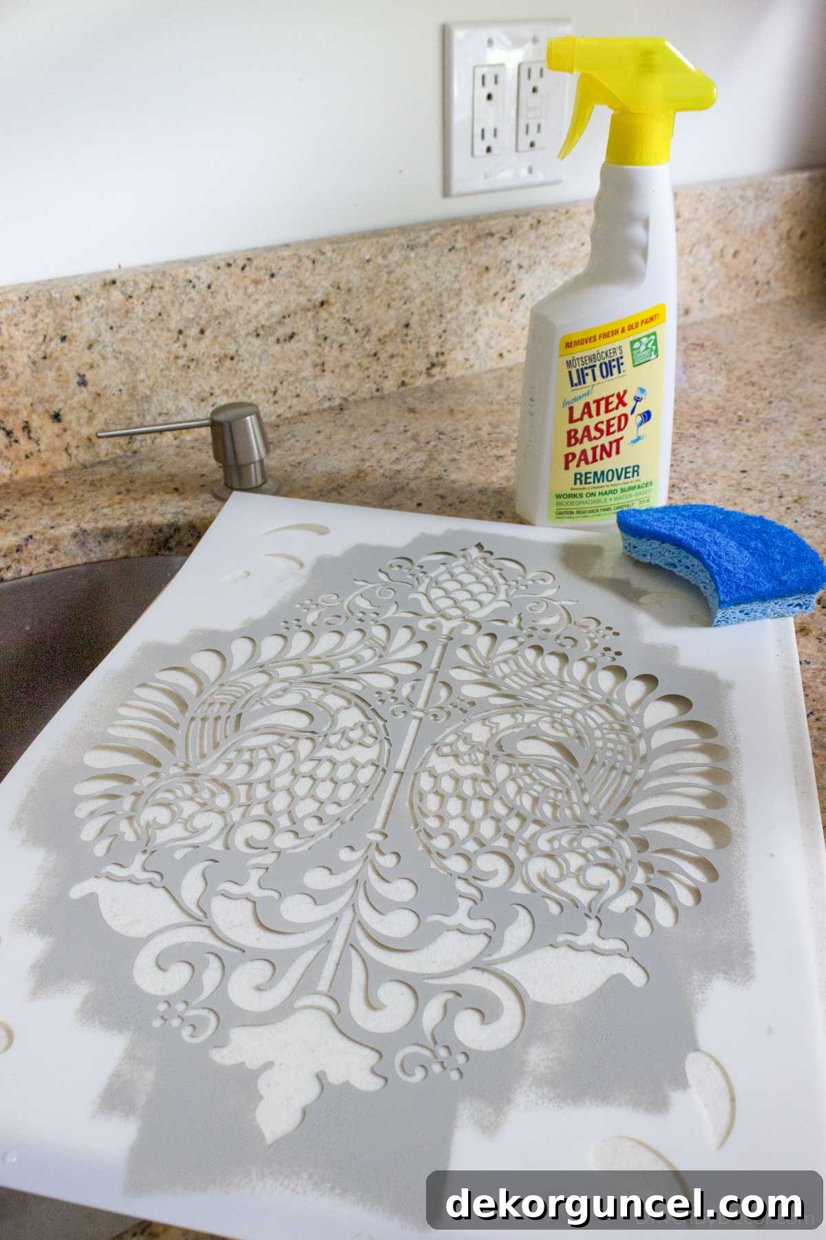 Şablonla Duvarlarınıza Hayat Verin: Büyüleyici Alanlar Yaratın 13 A wall stencil being cleaned with a latex paint remover spray, highlighting the ease and effectiveness of specialized products for maintaining stencil quality.