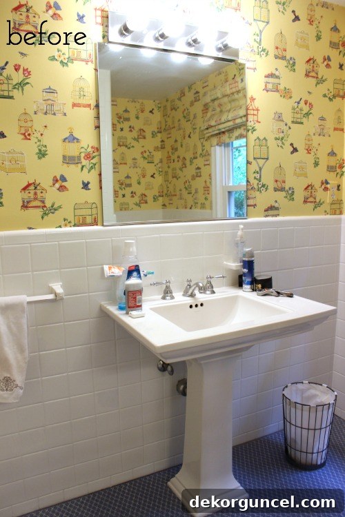 Şablonla Duvarlarınıza Hayat Verin: Büyüleyici Alanlar Yaratın 3 Before photo of a dated powder room featuring an old mirror, simple sink, and standard lighting fixtures, highlighting the need for a refresh.