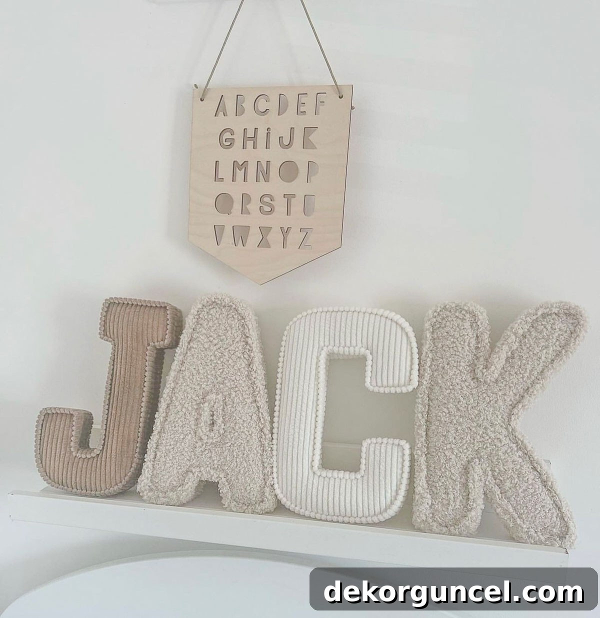 Decorative Letters: Top Sources and Creative Home Decor Ideas 8 Soft, neutral fabric decorative letters arranged on shelving in a baby's room, offering both charm and safety.