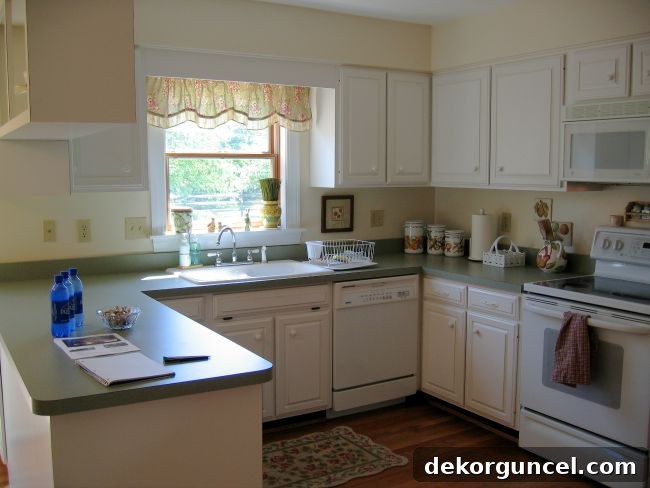 Kitchen before - a dated kitchen with dark cabinets and older appliances