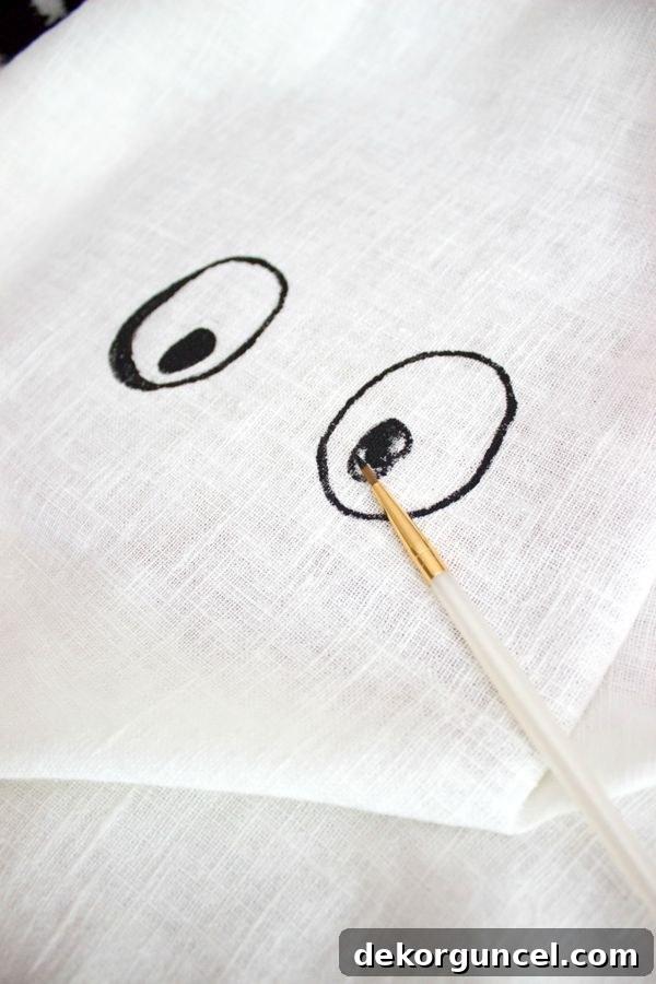 Paint eyes on pillow with craft paint