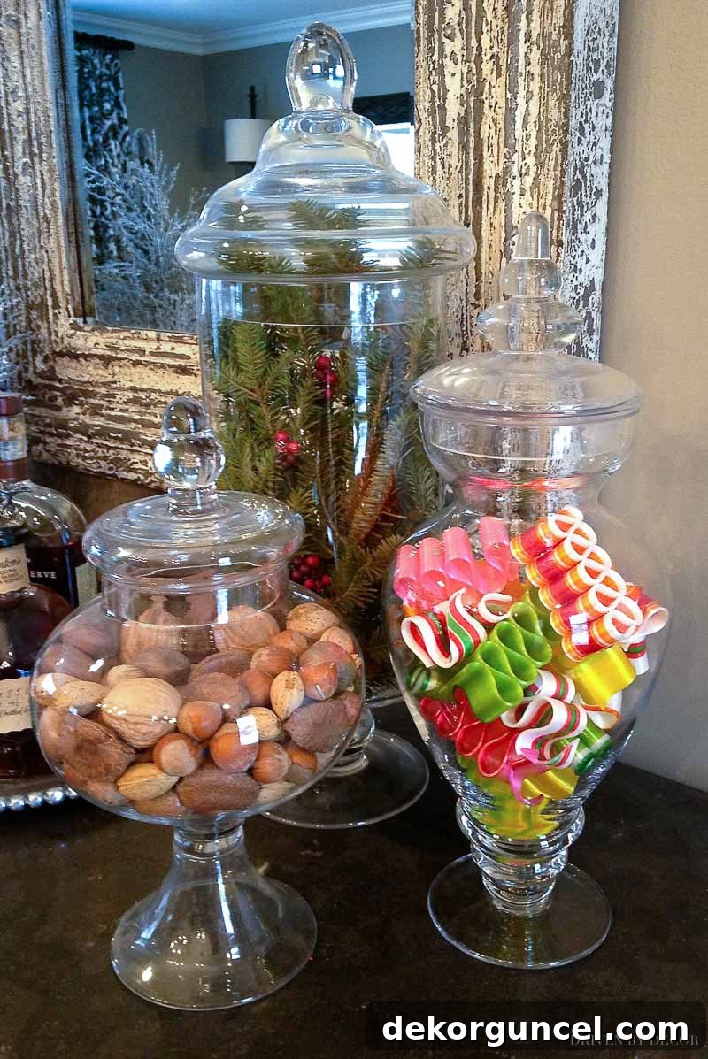 Elevate Your Home with Apothecary Jars 11 Apothecary jars filled with nuts, ribbon candy, and greenery for Christmas!