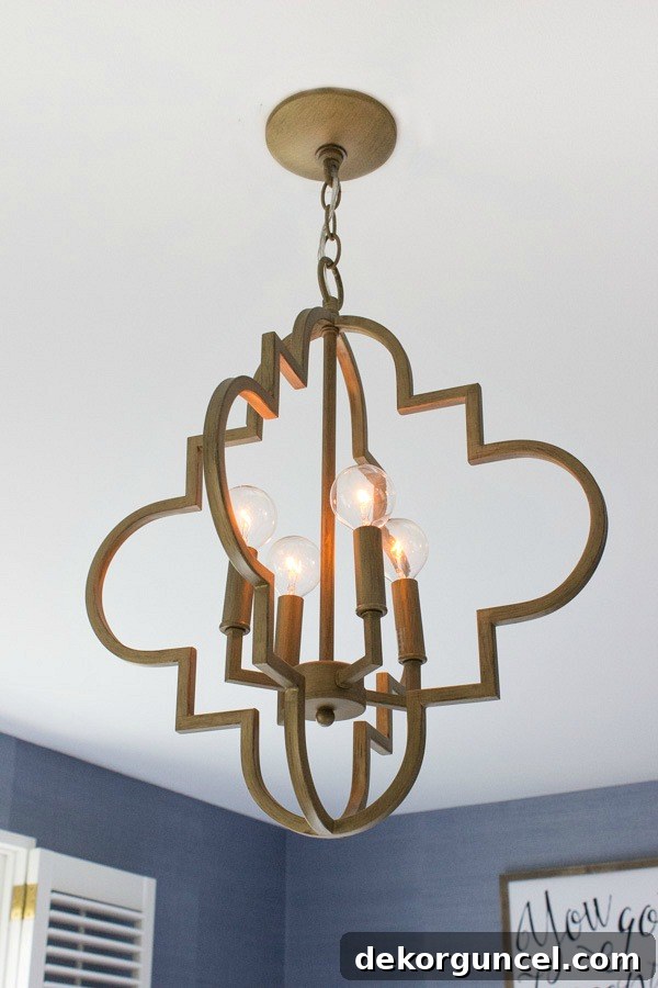 Beautiful gold arabesque chandelier - looks so cute in this bedroom!