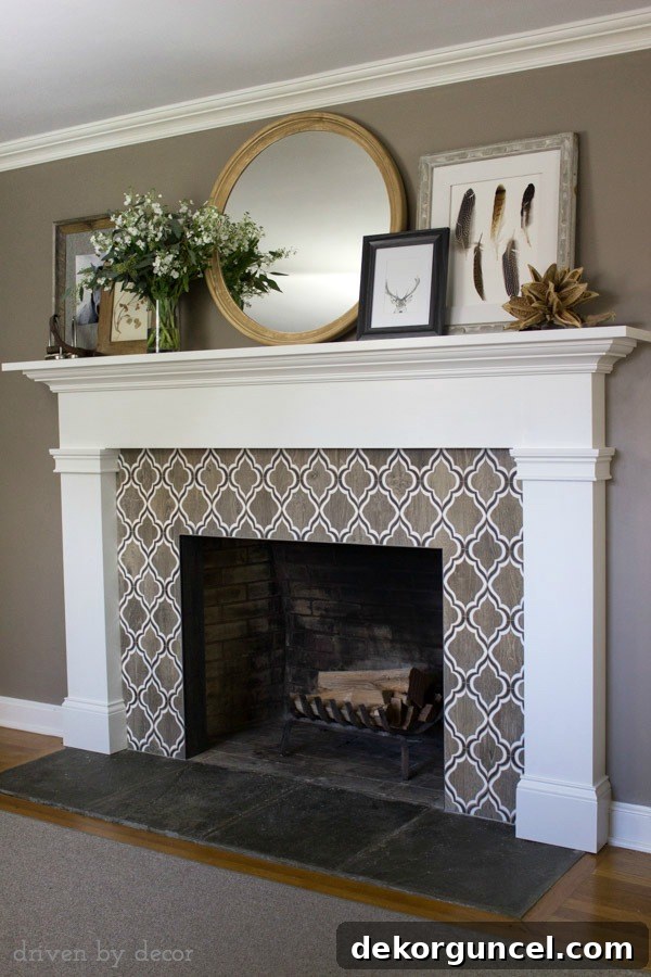 Full view of the stunning renovated fireplace with its beautiful tile, large round mirror, and layered art