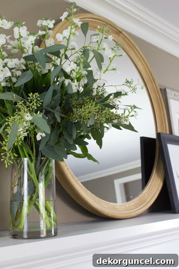 Close-up of the round wooden mirror, enhanced with a custom sanded finish, on the fireplace mantel