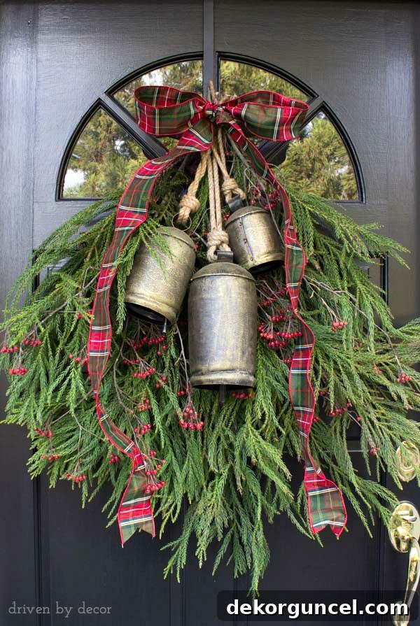 Quintessential New England Christmas Style 2 A welcoming holiday door decoration made with backyard clippings of greenery and berry branches, adorned with festive bells for a classic New England Christmas look.