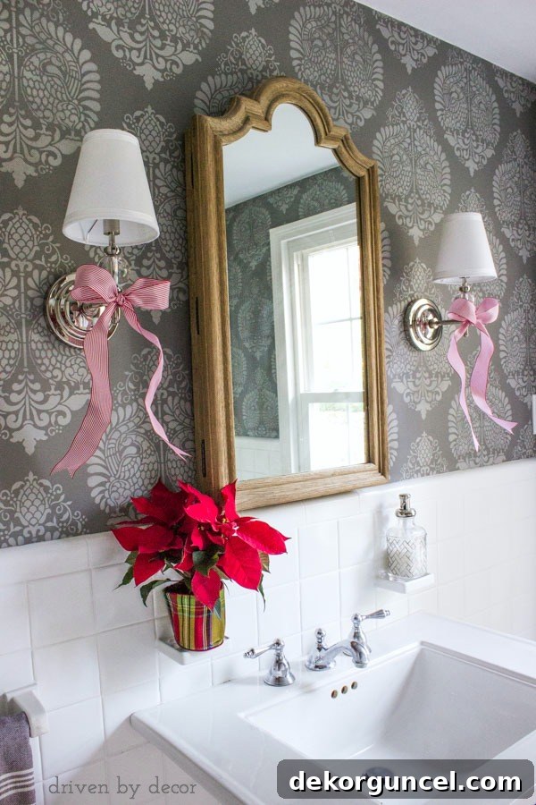 Quintessential New England Christmas Style 18 A charming powder room featuring distinct stenciled walls, subtly enhanced with simple yet elegant holiday decorations to create a festive ambiance.